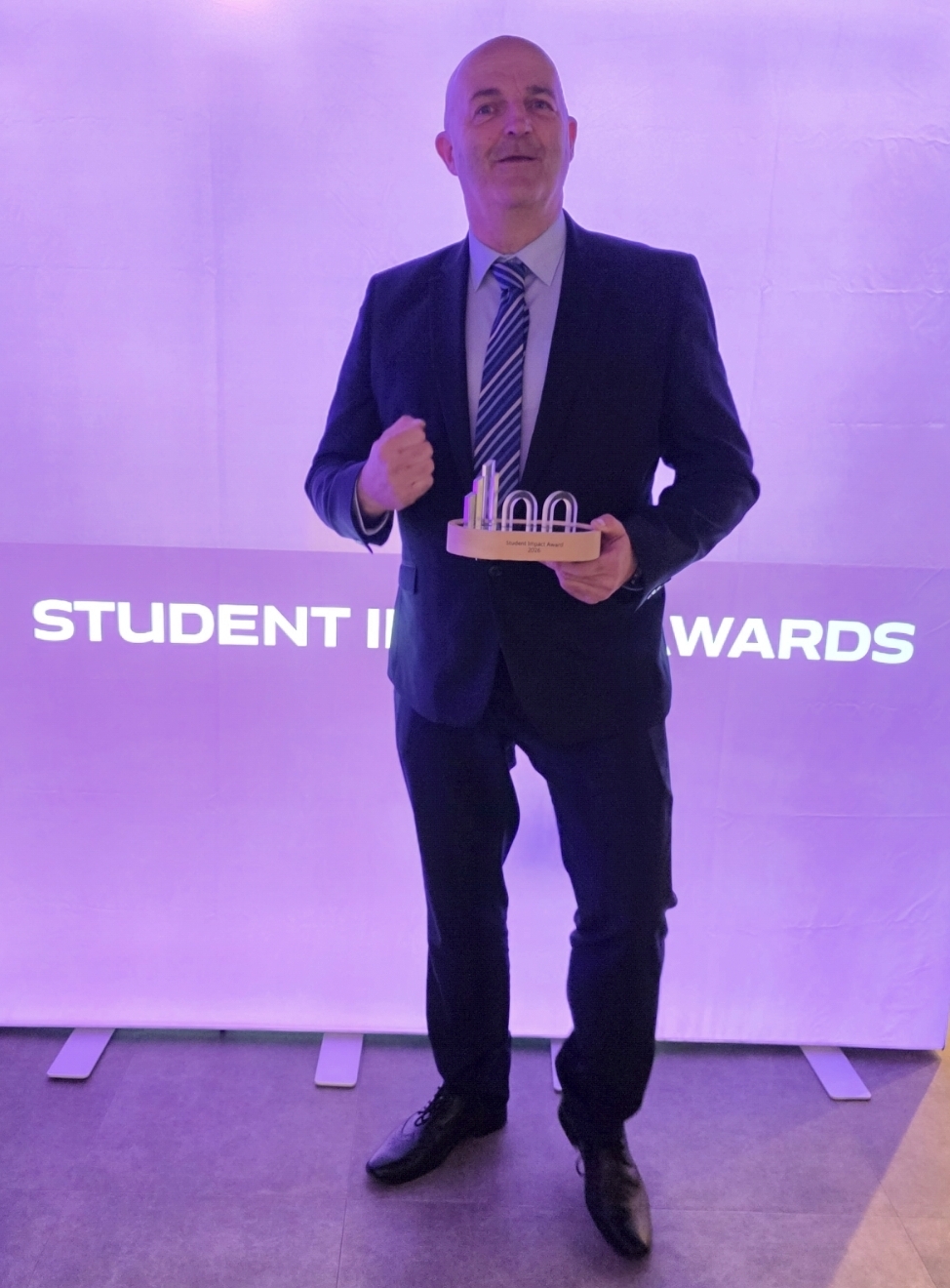 John Ryder holding University of Portsmouth Alumni Impact Award