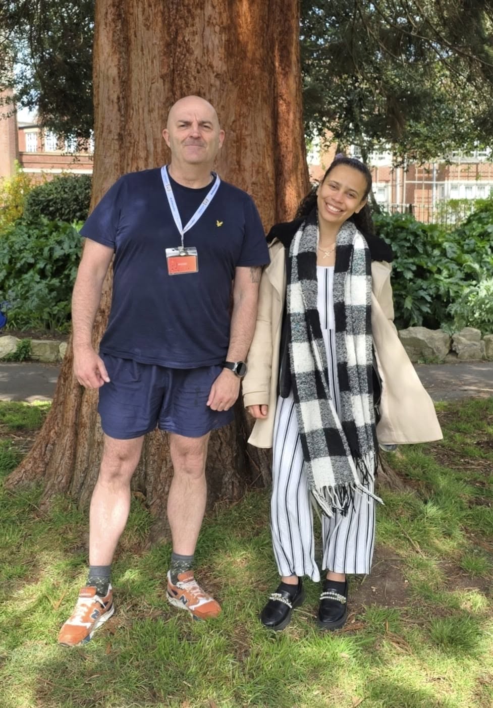 John Ryder standing with a community member outdoors