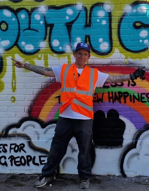 Neil from Art Form standing in front of community street art