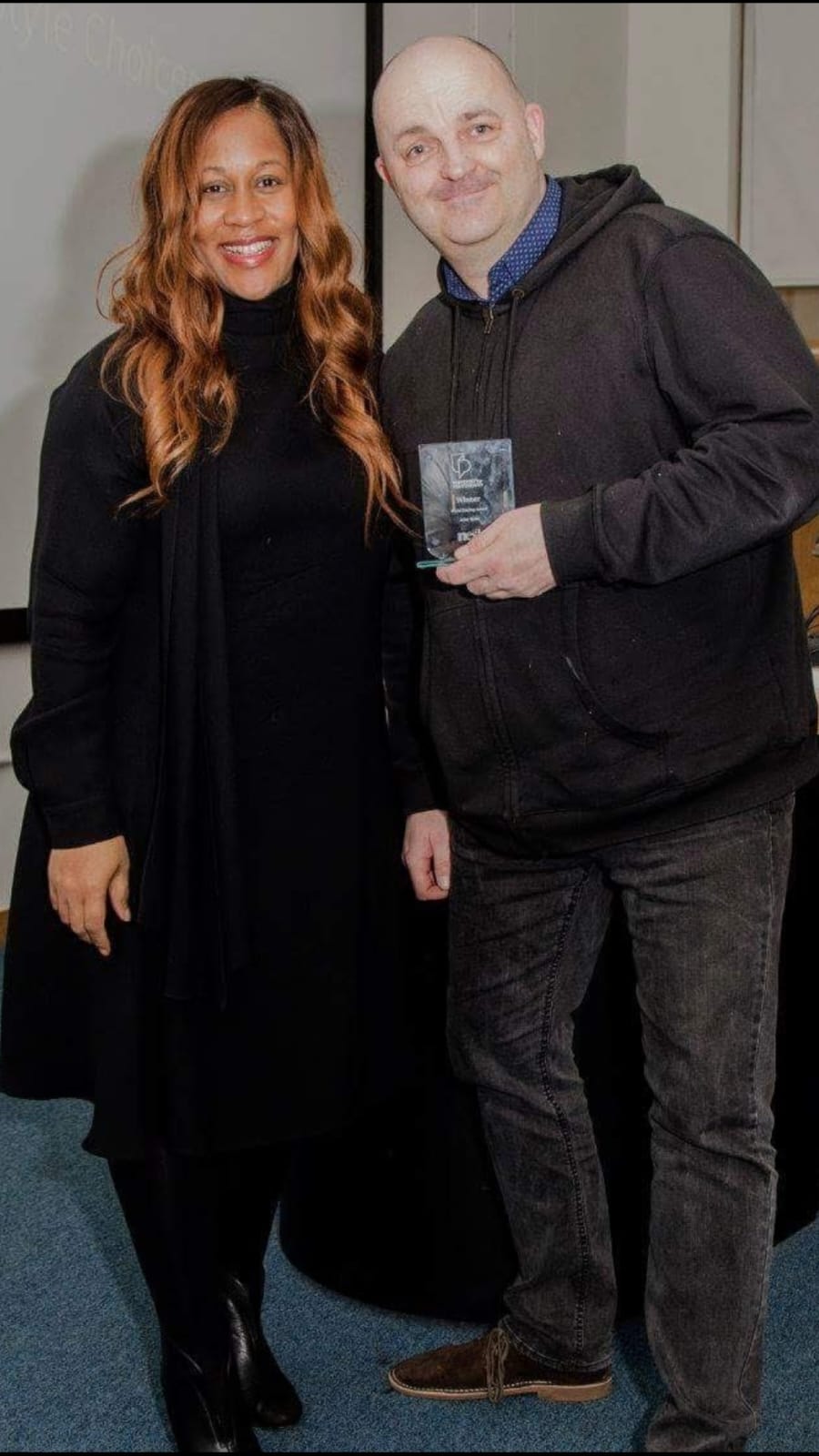 John Ryder receiving recognition with Karen Blackett